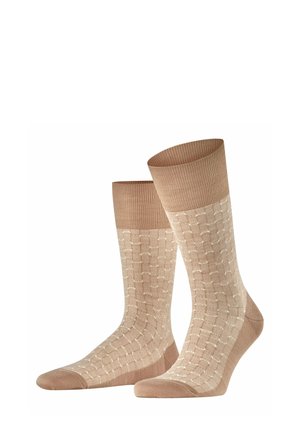 Beige Socken mit einem strukturierten Design und einem hellen Muster. Rippenbündchen oben, glatte Textur und verstärkte Zehen.
