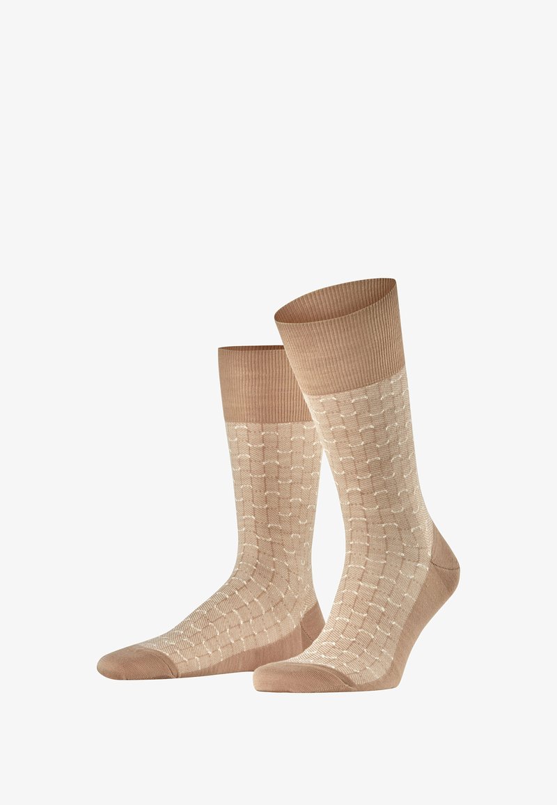 Calze beige con un design testurizzato caratterizzato da un leggero motivo. Orlo a coste nella parte superiore, tessuto liscio in tutto il corpo e punta rinforzata.