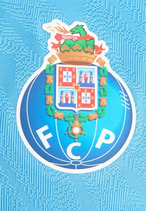 Blåt tekstilbaggrund med FC Porto-emblem, der indeholder en krone, drage og våbenskjold. Designet har grønne og gyldne accenter.