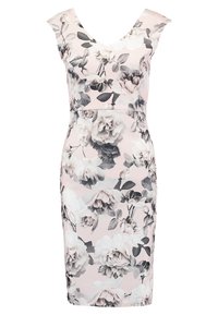 Kukallinen midi-mekko pehmeässä vaaleanpunaisessa värissä, musta-valkoisella pionikuviolla, mukautuvalla designilla ja V-pääntie, valmistettu joustavasta materiaalista.