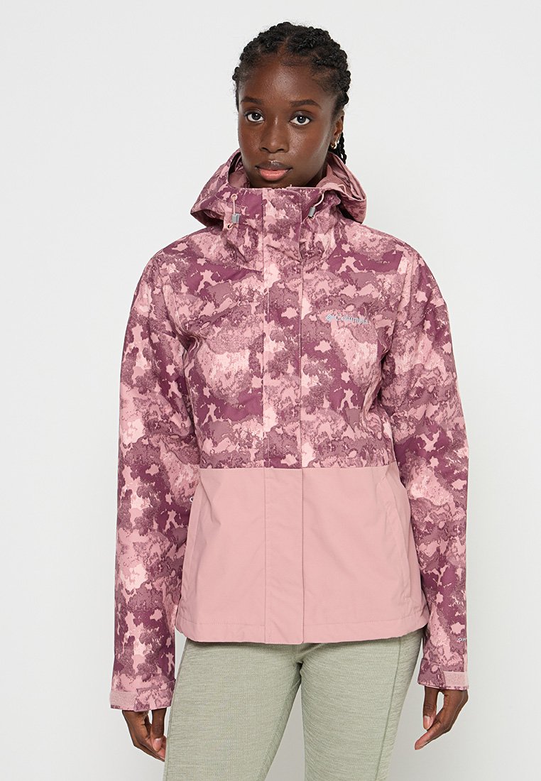 Lila- und rosa gefärbte Tarnjacke mit hohem Kragen, Reißverschluss und elastischen Bündchen. Leichtes Material mit glatter Textur.