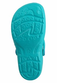 Turquoise rubber sandal sole featuring a textured design with circular patterns and grooves, marked with size information and “Made in Poland.”