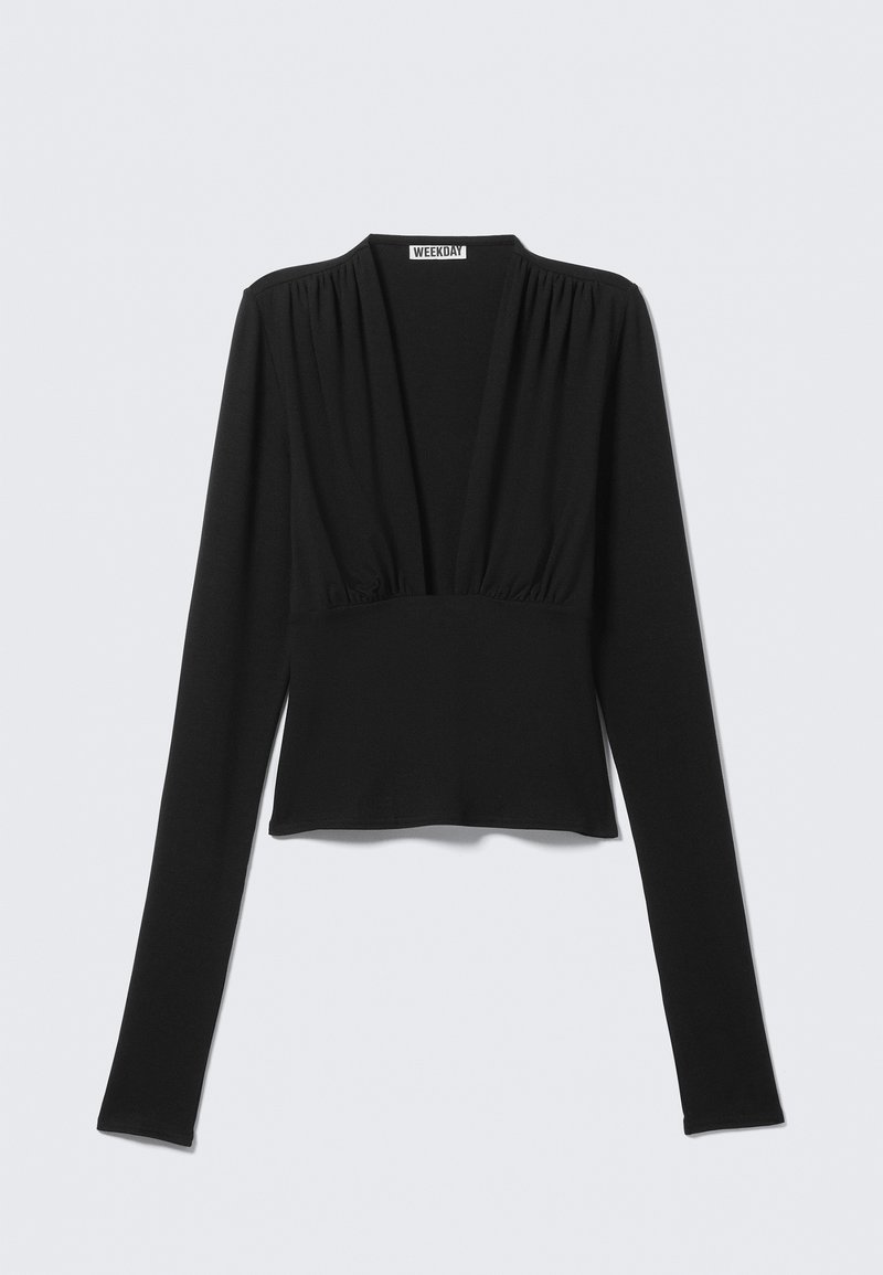 Blusa nera a maniche lunghe con scollo a V profondo, tessuto raggruppato sulle spalle e in vita, silhouette aderente.