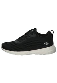 Black athletic shoes with a textured fabric upper, lace-up design, and a white rubber sole featuring ridges for traction.