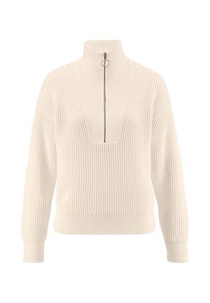 Crème ribbeltrui met een ritssluiting op de hoge kraag, diepe V-hals en lange mouwen. Heeft textuuraccenten langs de halslijn.