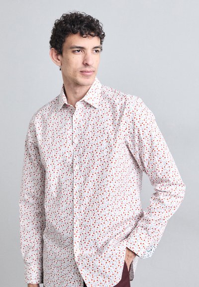 White button-up shirt featuring a floral pattern with red and blue accents, long sleeves, and a standard collar; smooth fabric texture.