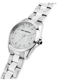 Orologio in acciaio inossidabile argentato con cassa rotonda, quadrante decorato con cristalli scintillanti e bracciale a maglie. Presenta un display della data e una corona nera.