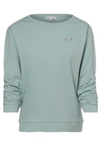 Kardigan z długim rękawem w jasnym zielonym kolorze, z okrągłym dekoltem i marszczonymi rękawami. Posiada haftowany napis "DOBRE WIBRACJE" w kolorowej stylistyce.