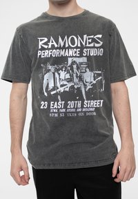 Gray cotton t-shirt featuring a vintage Ramones graphic in white and black, with a distressed texture and relaxed fit.