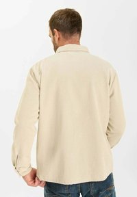 Beige corduroy shirt met lange mouwen, met een kraag en een ronde zoom, met ribbelstructuur en een relaxte pasvorm.