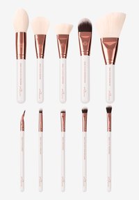 Set of ten makeup brushes with white handles and rose gold ferrules. Features various shapes and sizes, including angled and tapered brushes.