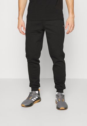 ESSENTIALS - Tracksuit bottoms - black