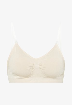 Beige, seamless bralette with a v-neckline, gathered center detail, and adjustable straps. Soft, stretchy fabric with a smooth texture.