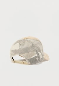 Boné com frente felpuda bege e parte de trás em rede. Apresenta uma correia ajustável de plástico e pala estruturada. Design texturizado e respirável.