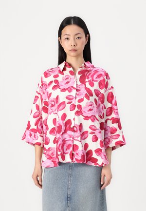 White shirt with a pink floral print, featuring a button-up front and notched collar, made from lightweight material; loose fitting sleeves.
