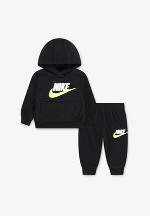 Black Nike hoodie with a front pocket and neon yellow logo, paired with matching black joggers featuring the same logo on the thigh.