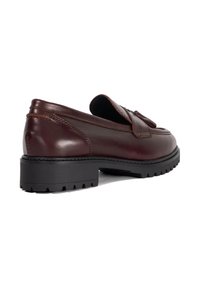 Brown leather slip-on shoe with a textured finish, featuring a rounded toe and a black rubber sole with a tread pattern.