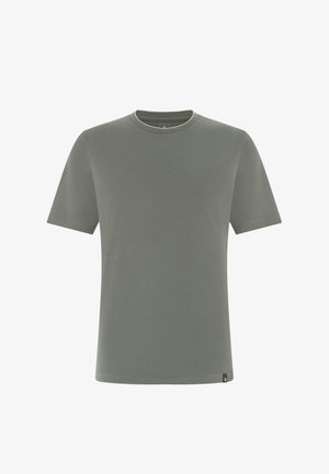 Schlichtes T-Shirt mit kurzen Ärmeln und Rundhalsausschnitt in gedämpftem Olivgrün mit einem kleinen schwarzen Markenzeichen am unteren Saum.