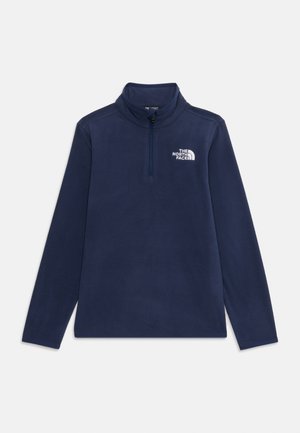 Dunkelblauer Fleece-Pullover mit hohem Kragen und Viertelreißverschluss. Mit einem weißen Logo auf der linken Brust und langen Ärmeln. Weiche Textur.