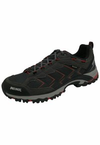 Black and gray athletic shoe featuring a mesh upper, red accents, textured outsole, and prominent brand logo on the side.