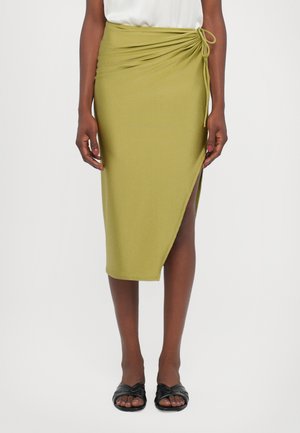 Olive green wrap skirt with side tie detail, featuring a mid-length cut and a slight slit. Made of a smooth, stretchy material.