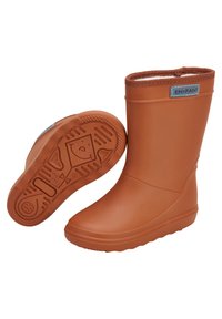 Bottes de pluie en caoutchouc orange avec une texture lisse, un dessus arrondi et une semelle antidérapante ornée d'un motif de visages souriants. Doublées d'une bordure marron.