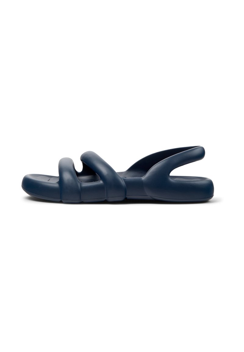 Navy blue slide sandals with three curved straps, made of flexible material, featuring a textured sole for grip and comfort.