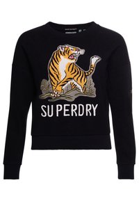 Svart tröja med en broderad tigerdesign och texten "SUPERDRY" i vitt. Tillverkad av mjukt material med ribbade mudd och nederkant.