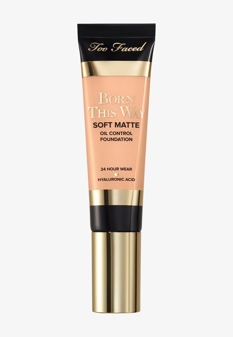 Too Faced Born This Way Soft Matte oil control foundation tube with gold and black cap, labeled 24 hour wear and hyaluronic acid.