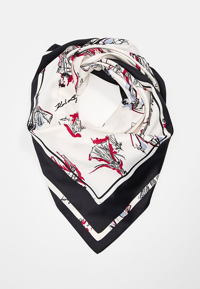 Sciarpa di seta con base bianca, caratterizzata da motivi artistici neri e rossi, piegata a forma triangolare. I bordi presentano un contrastante bordo nero.