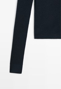 Navy ribbed knit sweater with long sleeves, featuring a fitted design and smooth texture. Includes a neatly finished hem at the bottom.