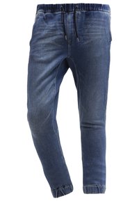 Modré džínové jogger kalhoty s elastickým pasem, šňůrkou, zúženými nohavicemi a jemným zesvětlením. Manžeta na spodním okraji a elegantní designové detaily.