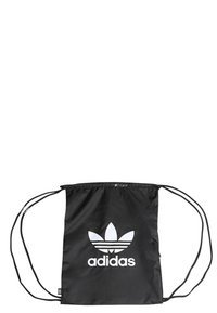 Black drawstring bag made of nylon, featuring a large white Adidas trefoil logo at the center and adjustable black cords for closure.