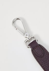 Dark purple leather strap with silver-toned metal hardware and a trigger snap clasp, featuring visible texture and stitching details.
