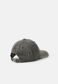 Worn gray baseball cap with metal buckle strap, six stitched panels, and ventilation eyelets on white background.