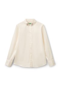 Camicia a maniche lunghe con bottoni in cotone color crema con colletto. Presenta un delicato ricamo a foglia vicino al colletto. Tessuto morbido, taglio classico.