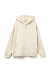 Felpa con zip color beige chiaro, realizzata in tessuto morbido, caratterizzata da una vestibilità ampia, un grande cappuccio e due tasche frontali.