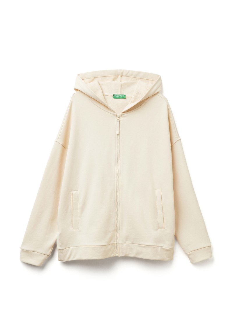 Felpa con zip color beige chiaro, realizzata in tessuto morbido, caratterizzata da una vestibilità ampia, un grande cappuccio e due tasche frontali.