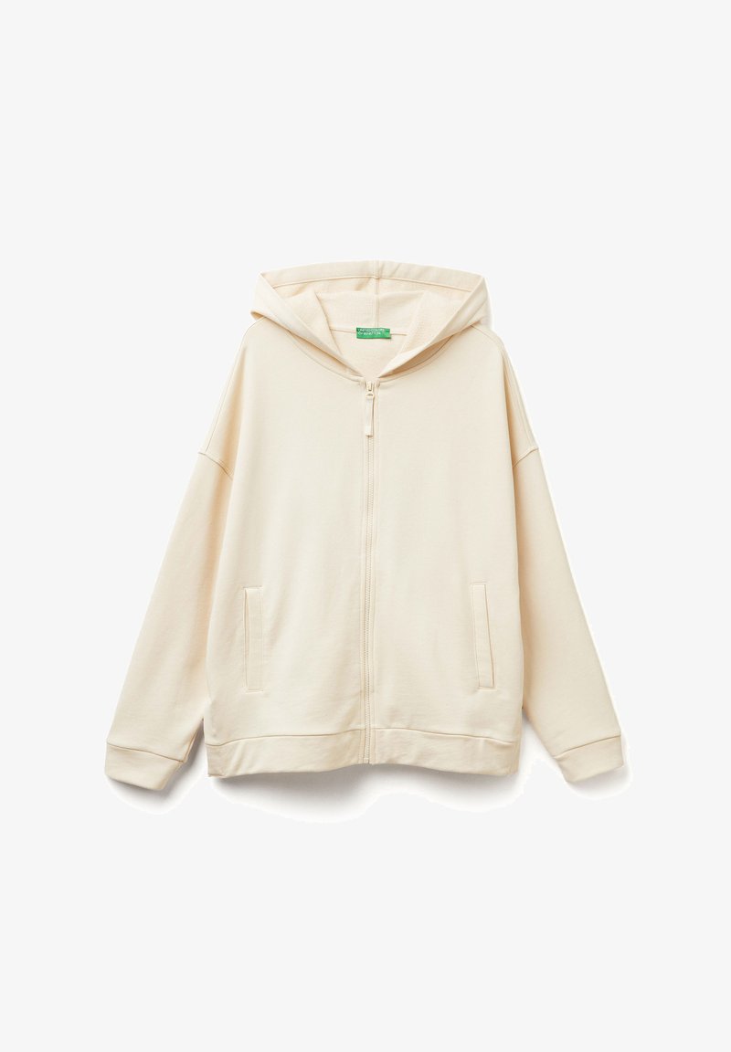 Felpa con zip color beige chiaro, realizzata in tessuto morbido, caratterizzata da una vestibilità ampia, un grande cappuccio e due tasche frontali.