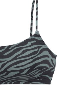 Svakodnevni grudnjak sa crno-sivim printom zebra, sa podesivim trakama, ravnim šavovima i mekim, rastezljivim materijalom. Ima minimalistički dizajn.