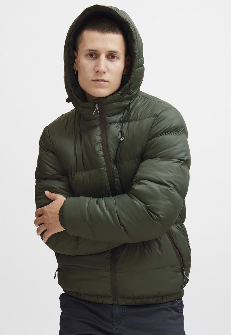 Green puffer jacket with a hood, featuring a zip front, elastic cuffs, and side pockets. Smooth, glossy fabric with quilted pattern.