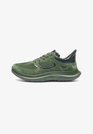 Green suede and mesh athletic shoe with black accents, thick sole, and lace-up closure, shown in side profile on white background.