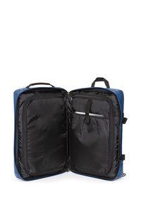 Blå hårdskalryggsäck med svart inredning, utrustad med en dragkedjeficka och ett vadderat fack för en bärbar dator. Justerbara remmar ingår.