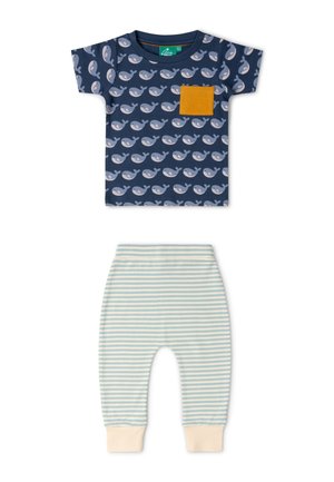 Navy blue toddler shirt with gray whale print and mustard pocket, paired with pale blue and white striped pants with cream cuffs.