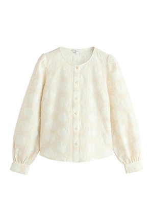 Bluză de culoare crem, cu mâneci lungi și voluminoase, cu închidere buton la față și țesătură texturată cu un model discret de cercuri. Material neted și ușor.
