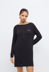 Black long-sleeve dress made of soft fabric with a relaxed fit. Features a wide neckline and a small white "BOSS" logo on the chest.
