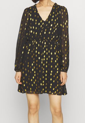 Schwarzes langärmliges Kleid mit goldenen metallischen ovalen Punkten, V-Ausschnitt, Knopfleiste vorne, tailliert und transparenten Ärmeln.