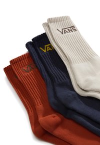 Set of four socks in ribbed knit: burnt orange, navy blue, cream, and dark gray. Each features the "VANS" logo in contrasting thread.