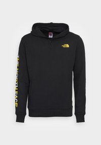 Schwarzer Hoodie aus Baumwollmischung, mit einem gelben Logo auf der Brust und Schriftzug entlang des Ärmels. Mit Kapuze mit Kordelzug und Kängurutasche.