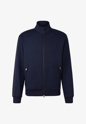 Námořnická modrá bundě na zip s vysokým límcem, dlouhými rukávy, žebrovanými manžetami a spodním lemem a dvěma postranními kapsami na zip.